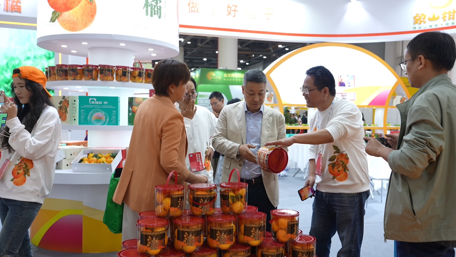 Trade visitors examining packaged fruit products at an iFresh exhibition booth