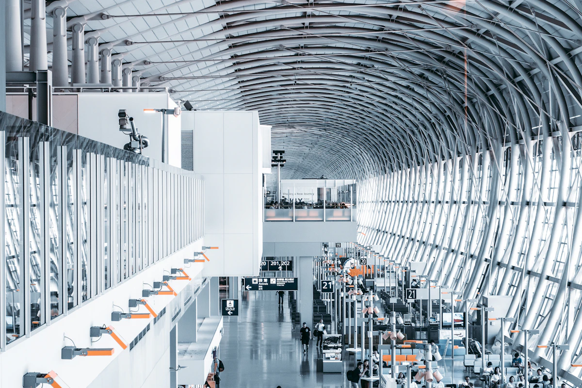 Travellers inside a bright airport terminal